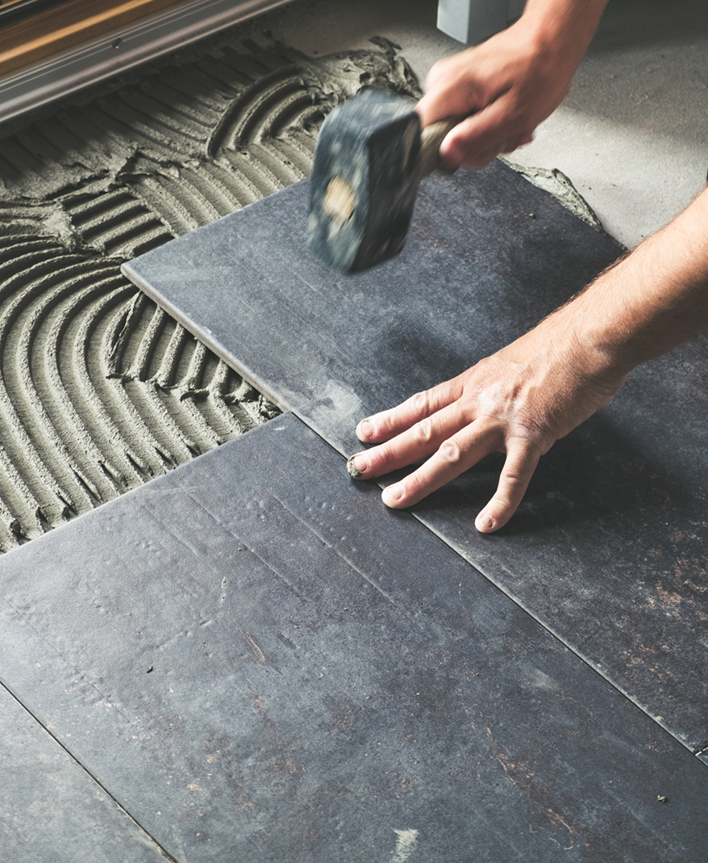 Installing floor tiles by hand